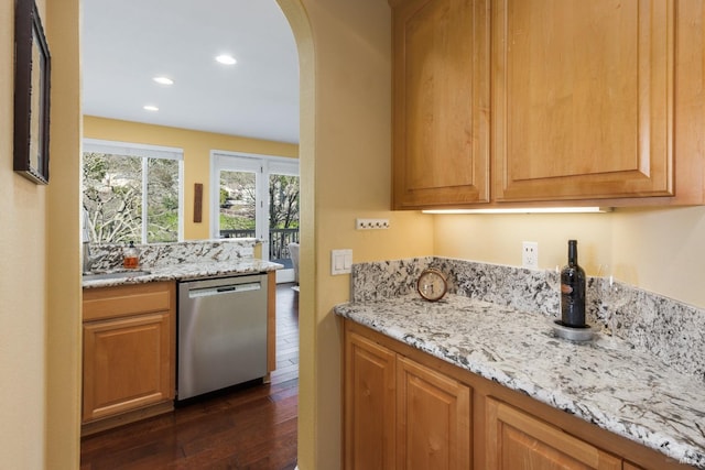 kitchen with dark hardwood / wood-style floors, dishwasher, and light stone countertops