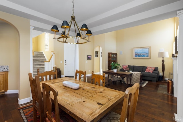 dining room with dark hardwood / wood-style flooring and a chandelier