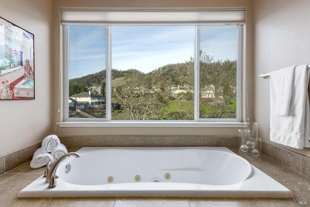 bathroom featuring tiled tub