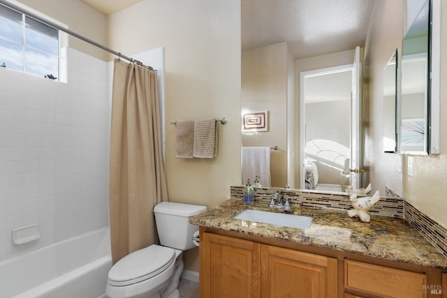 full bathroom featuring vanity, shower / bath combo with shower curtain, and toilet