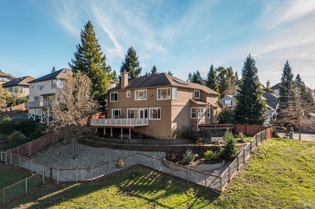 rear view of property featuring a yard and a pergola