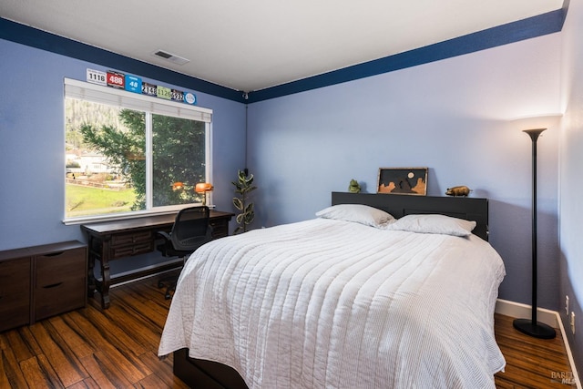 bedroom with dark wood-type flooring