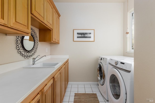 clothes washing area with washer and dryer, light tile patterned flooring, sink, and cabinets