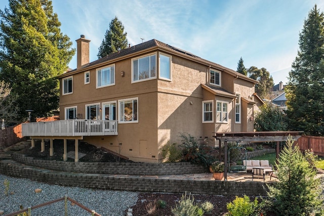 back of house featuring an outdoor hangout area, a pergola, a patio area, and a wooden deck