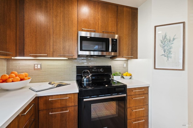 kitchen featuring tasteful backsplash and black electric range