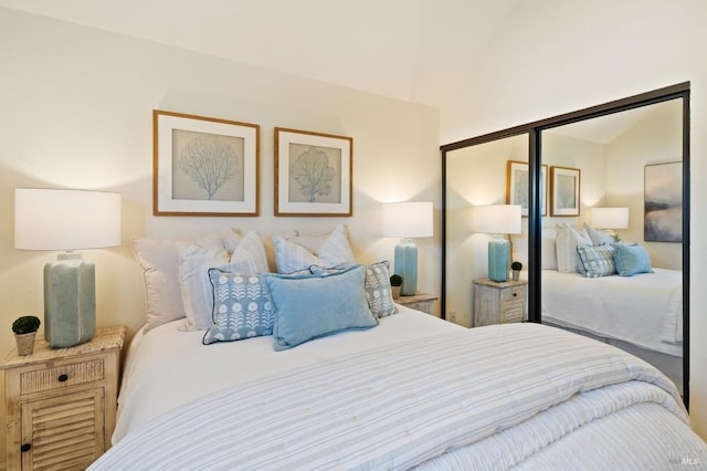 bedroom with vaulted ceiling and a closet