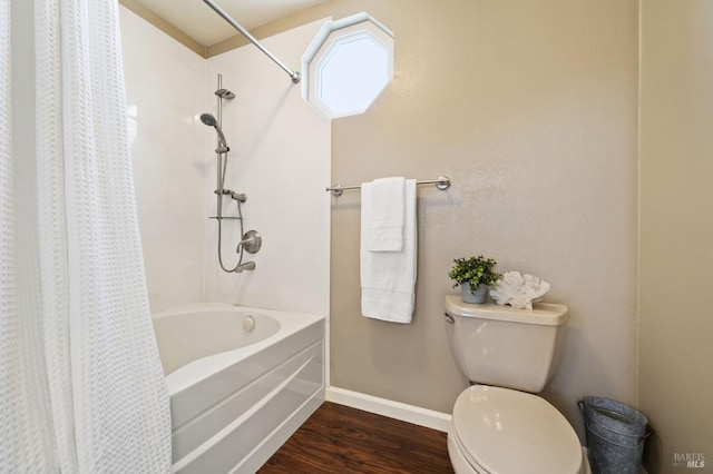 bathroom featuring wood-type flooring, shower / bath combo, and toilet