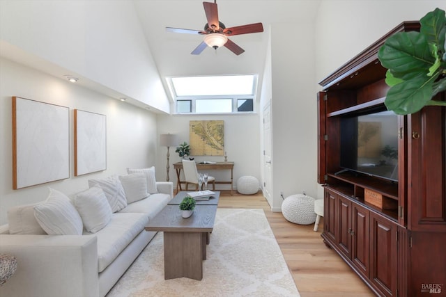 living room featuring ceiling fan, high vaulted ceiling, and light hardwood / wood-style floors