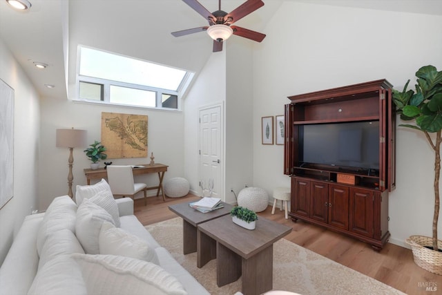 living room with light hardwood / wood-style flooring, high vaulted ceiling, and ceiling fan