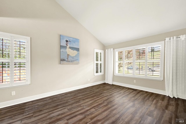 empty room featuring dark hardwood / wood-style floors and vaulted ceiling