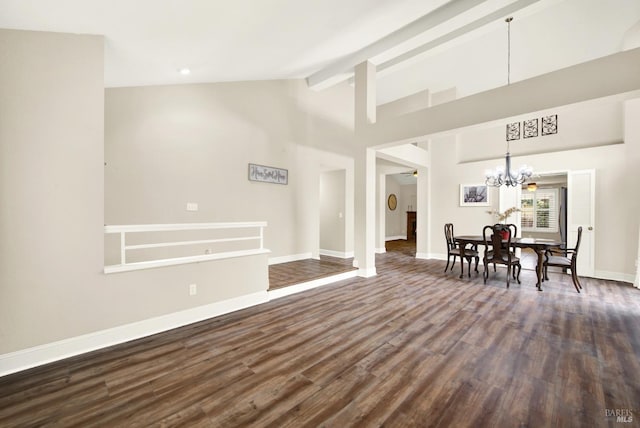 unfurnished living room featuring an inviting chandelier, dark hardwood / wood-style flooring, high vaulted ceiling, and beam ceiling