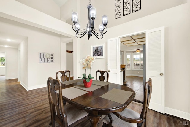 dining space featuring an inviting chandelier and dark hardwood / wood-style flooring