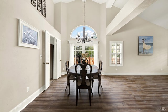 dining room with a high ceiling, dark hardwood / wood-style floors, and a notable chandelier