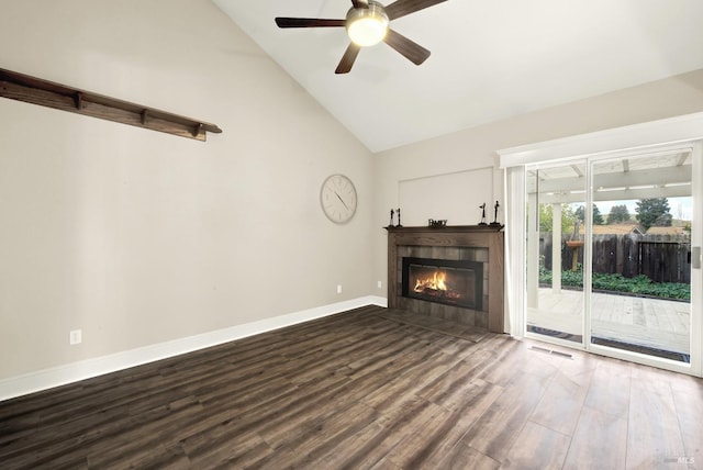 unfurnished living room featuring a tiled fireplace, hardwood / wood-style floors, high vaulted ceiling, and ceiling fan