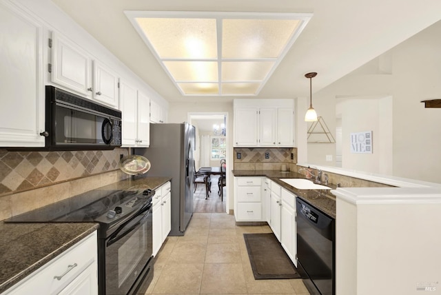 kitchen featuring pendant lighting, white cabinetry, sink, and black appliances