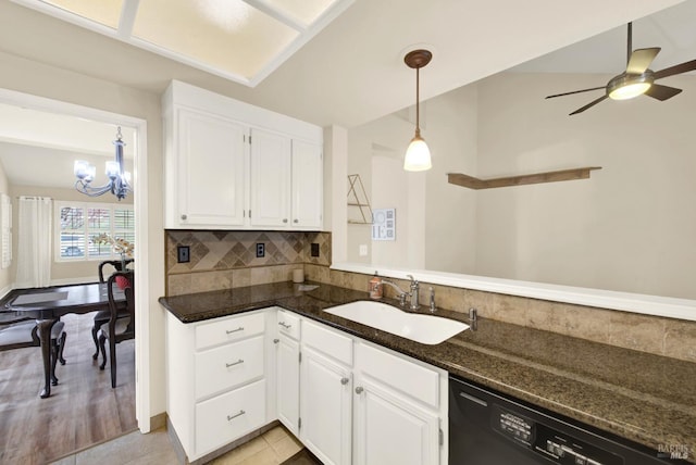 kitchen with sink, dishwasher, white cabinetry, decorative backsplash, and dark stone counters