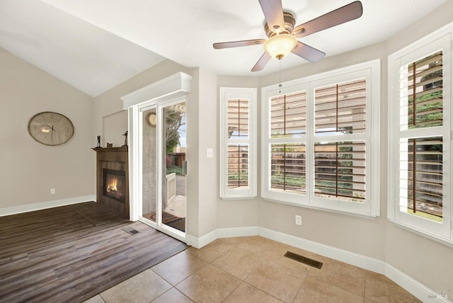 doorway to outside featuring vaulted ceiling, ceiling fan, and light tile patterned flooring