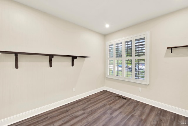 empty room with hardwood / wood-style flooring