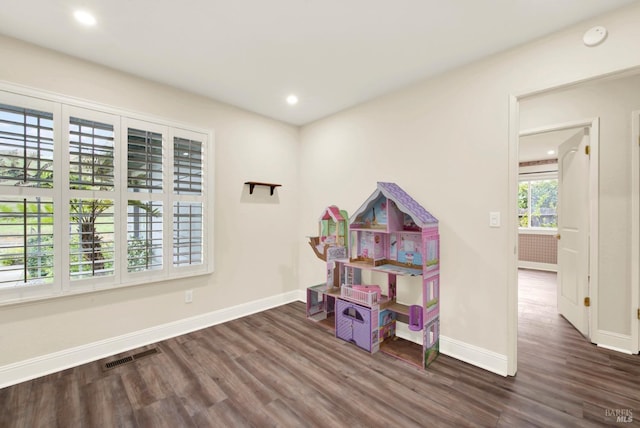 recreation room with dark hardwood / wood-style floors