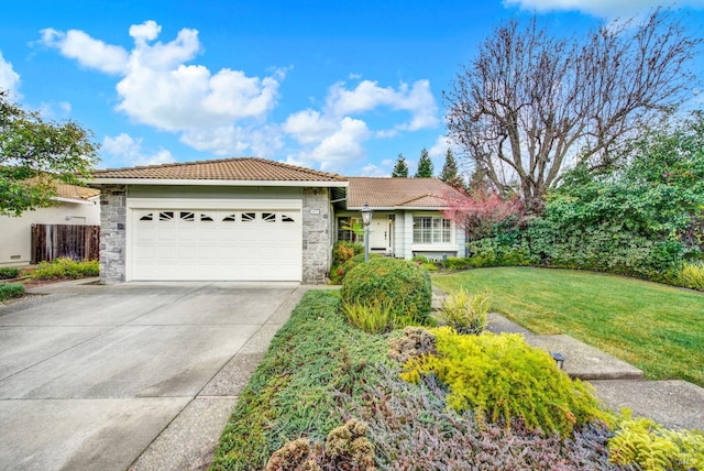 view of front of property featuring a garage and a front lawn