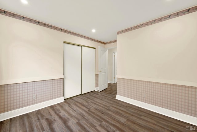 unfurnished bedroom with wood-type flooring and a closet