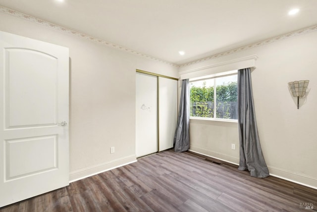 unfurnished bedroom with wood-type flooring and a closet