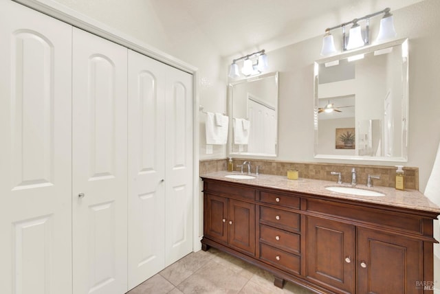 bathroom featuring vanity, decorative backsplash, and tile patterned floors