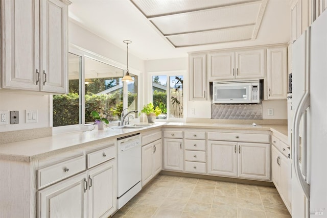 kitchen featuring white appliances, decorative light fixtures, sink, and decorative backsplash