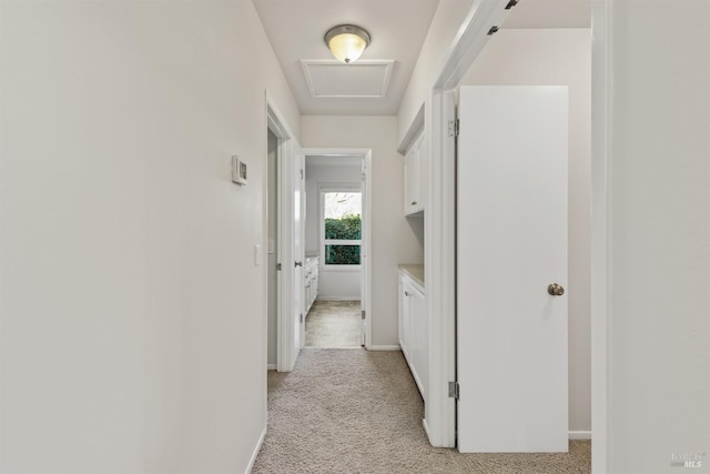 hallway featuring light colored carpet