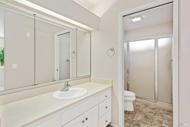 bathroom with vanity, a shower with shower door, and toilet