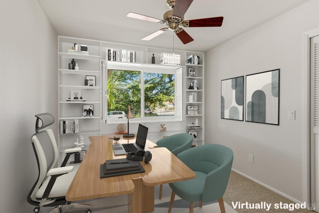 carpeted office featuring ceiling fan