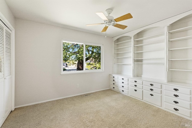 unfurnished bedroom featuring light carpet, a closet, and ceiling fan