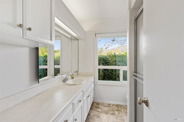 bathroom with vanity and walk in shower