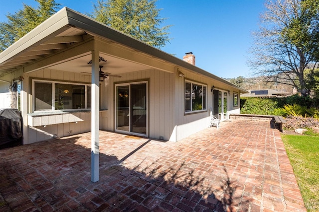 rear view of property with a patio and ceiling fan