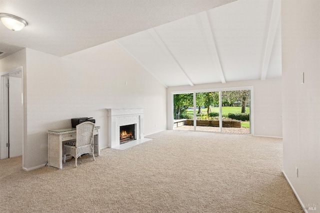 unfurnished living room with carpet floors and vaulted ceiling with beams