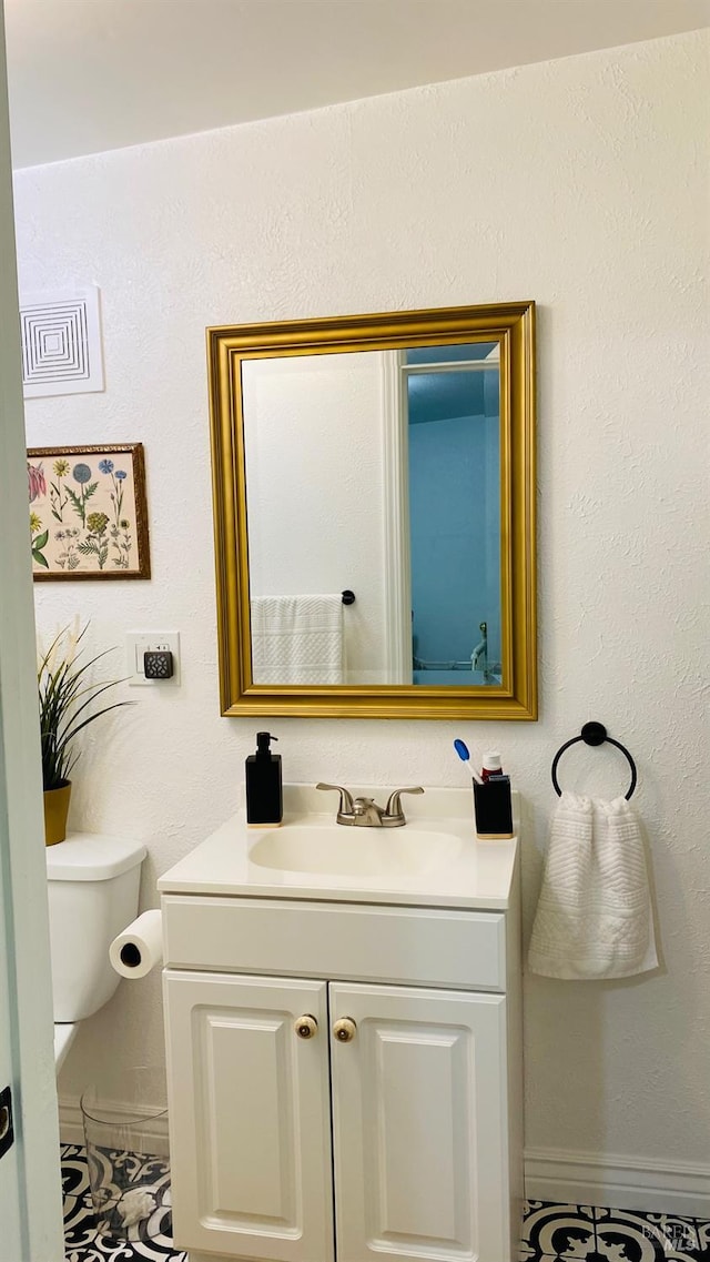 bathroom with vanity and toilet