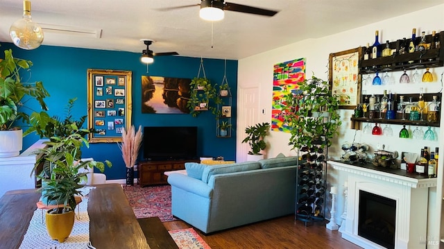 living room featuring dark hardwood / wood-style floors and ceiling fan