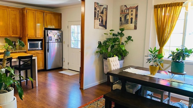 kitchen featuring appliances with stainless steel finishes and dark hardwood / wood-style floors