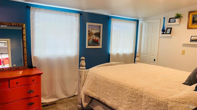 bedroom with multiple windows and carpet flooring