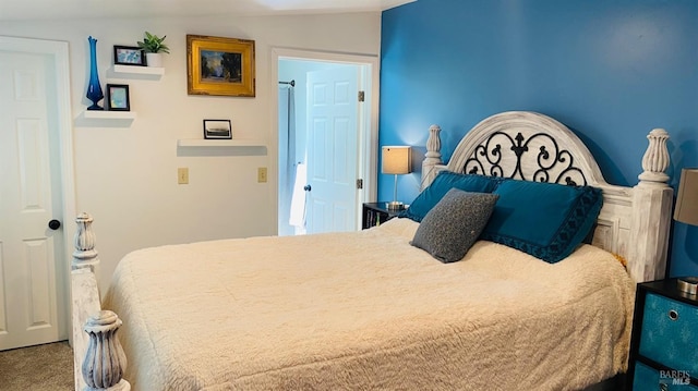 bedroom featuring vaulted ceiling and carpet flooring