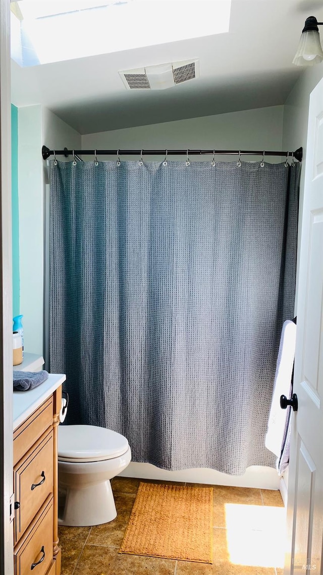 bathroom featuring a shower with curtain, tile patterned floors, vanity, and toilet