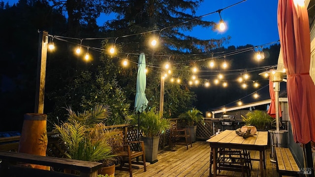 deck at night featuring area for grilling