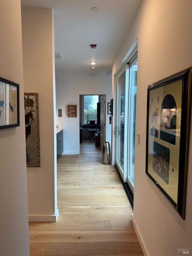 hall with light hardwood / wood-style flooring