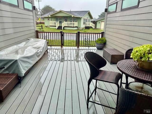 wooden terrace with a yard