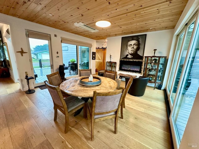 dining room featuring wood ceiling and light hardwood / wood-style flooring