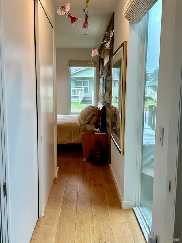 hallway with light hardwood / wood-style floors