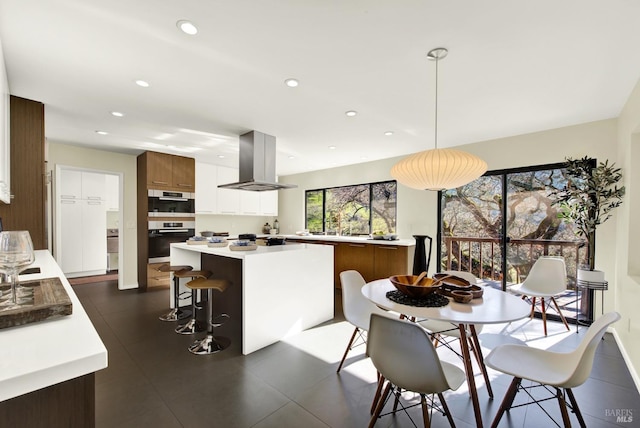 dining space with recessed lighting and baseboards