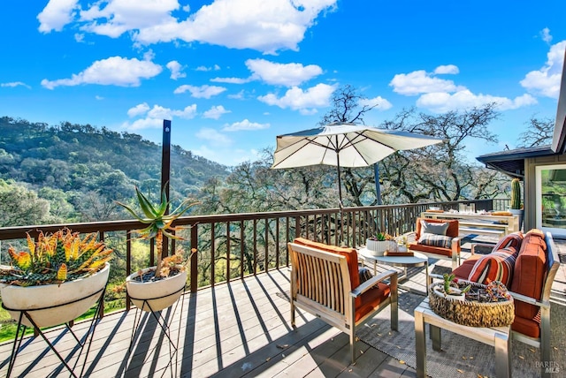 wooden terrace with an outdoor hangout area