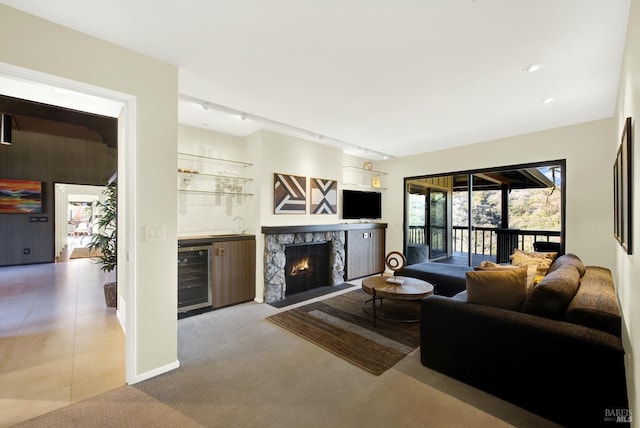 living room with carpet flooring, wet bar, and beverage cooler