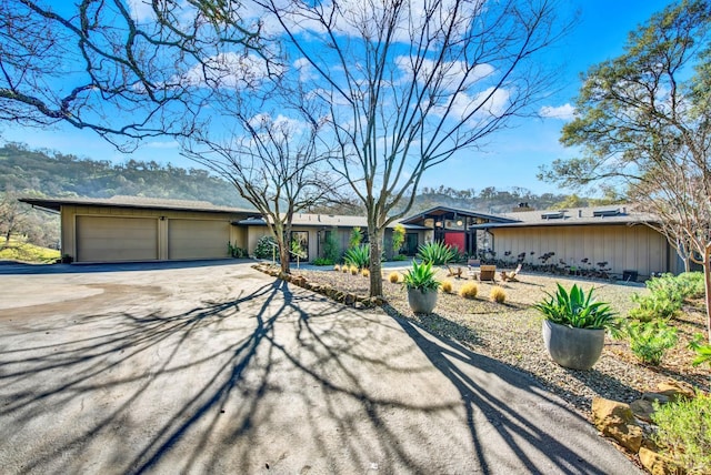 view of front of property with aphalt driveway and a garage